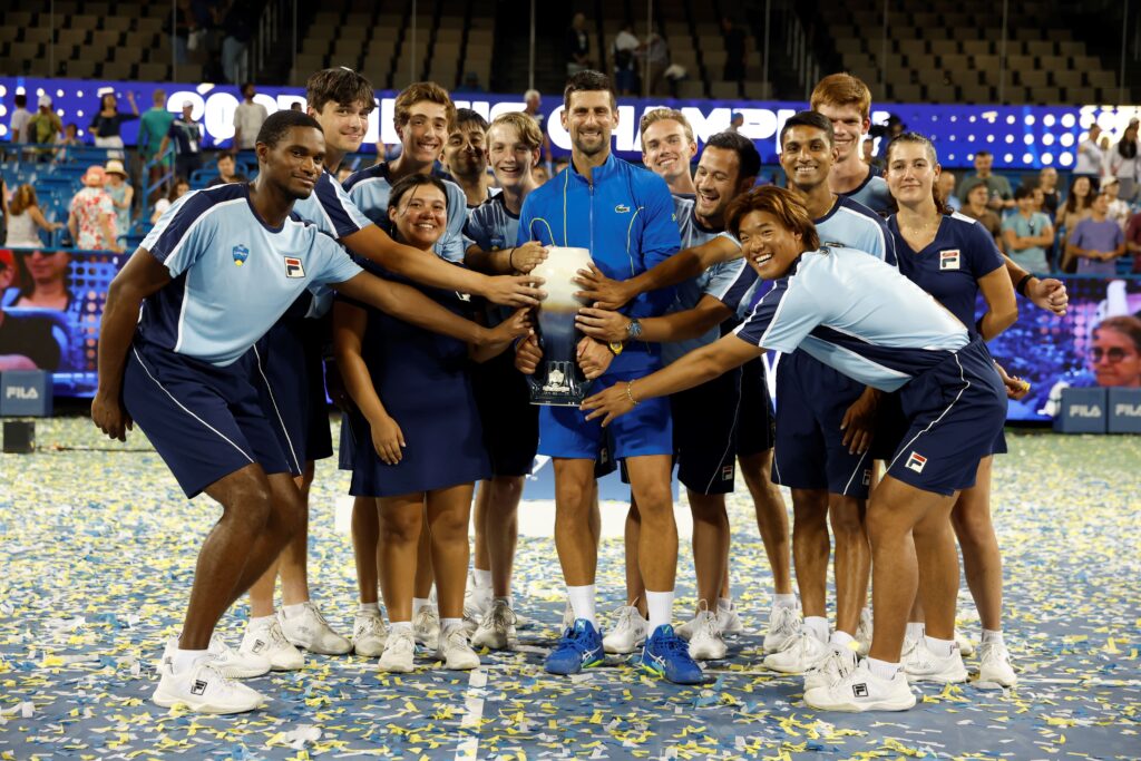 Novak Djokovic with a group of ball people