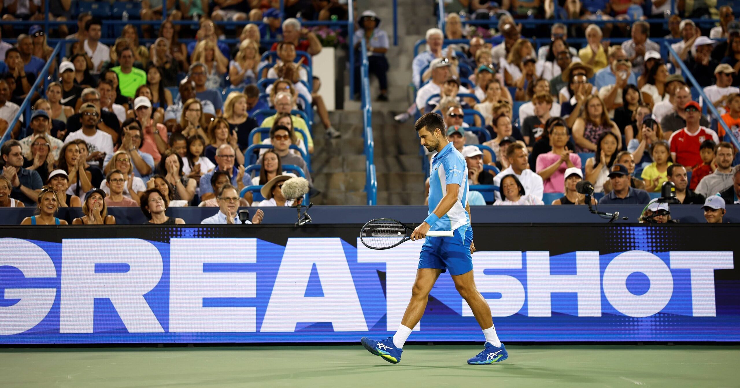 Novak Djokovic walking on a tennis court