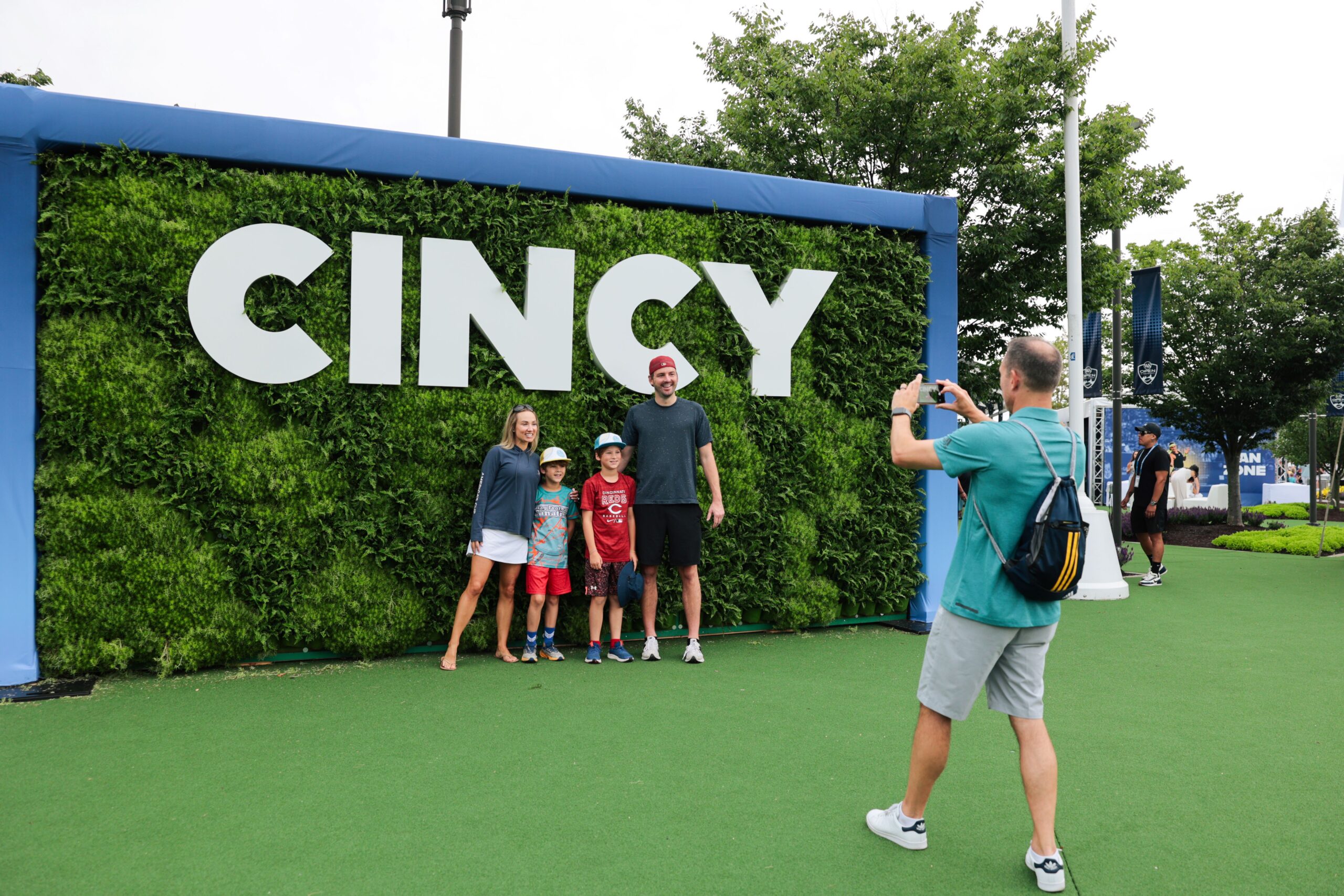 Family posing in front of a "Cincy" photo op