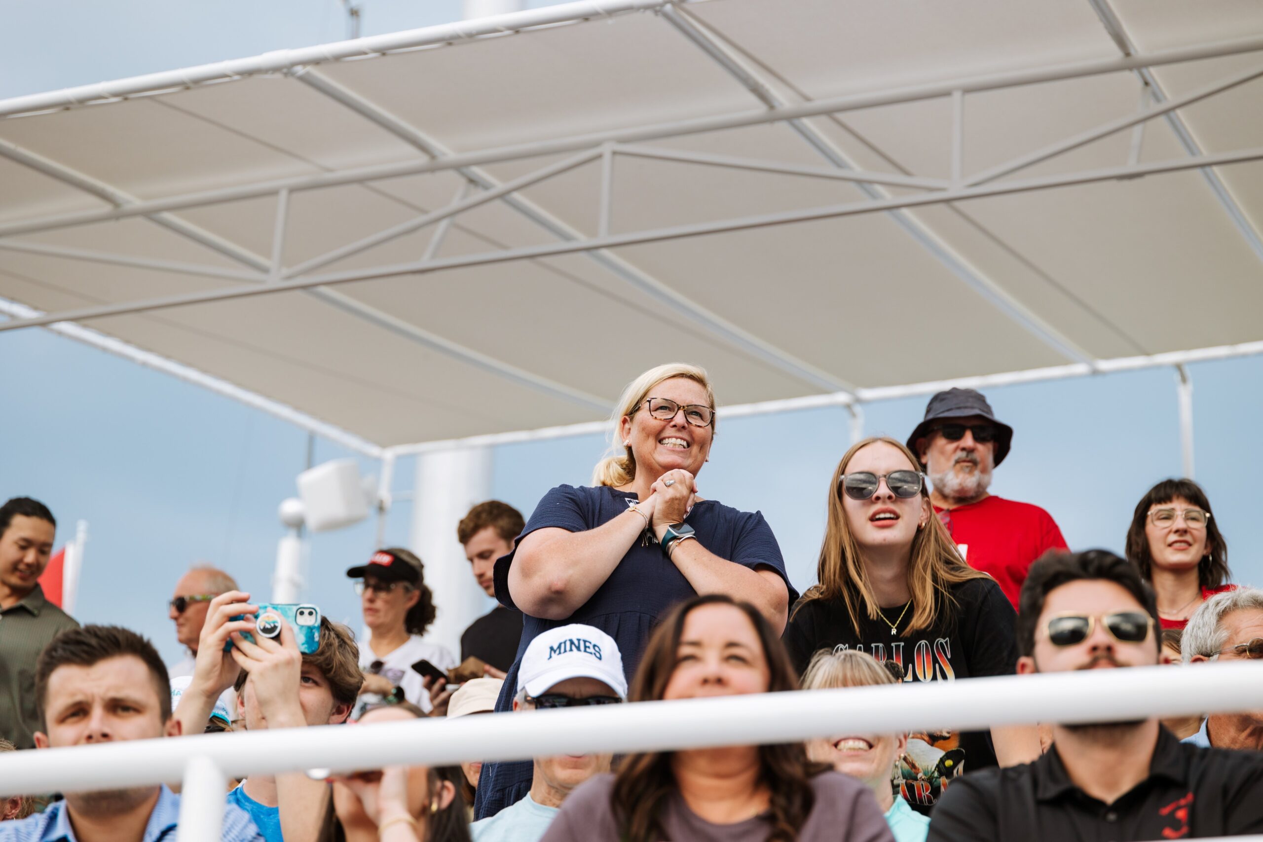 Woman looks expectantly from the stands