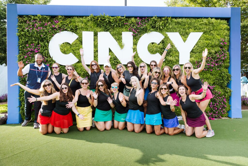 A group in front of a CINCY photo op