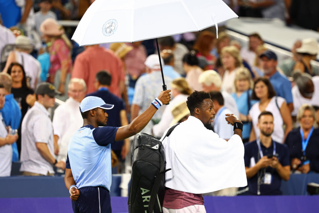 Gael Monfils with an umbrella over his head