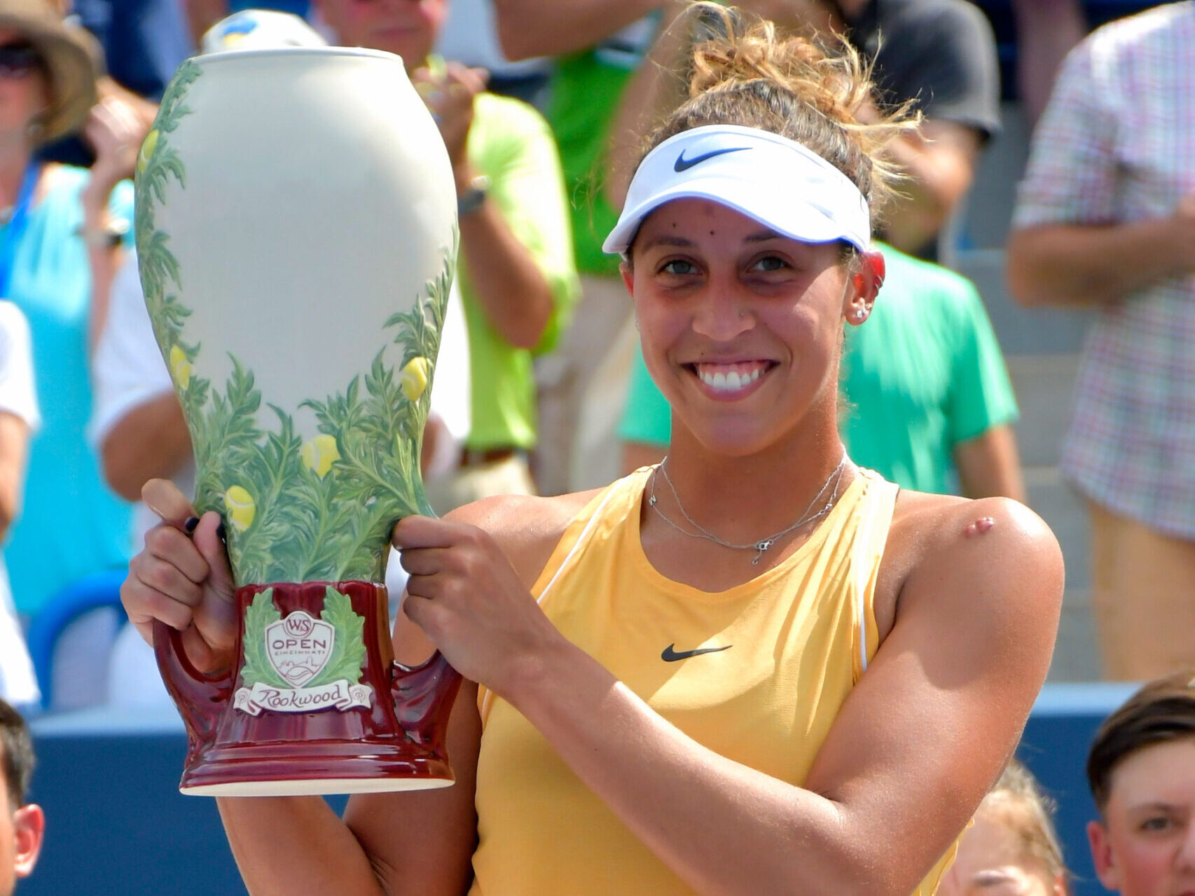 woman holding up trophy