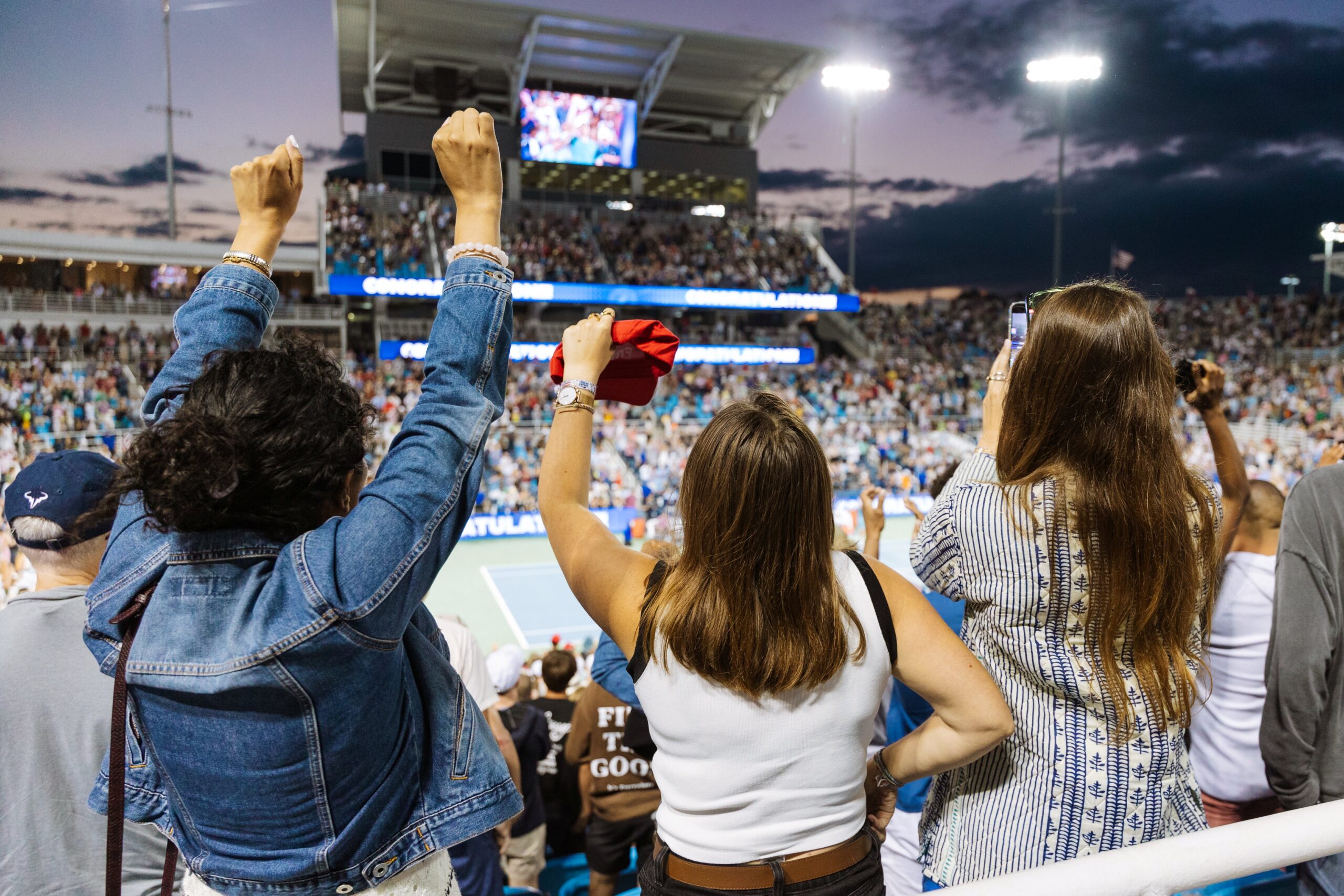 Fans cheer at a tennis tournament