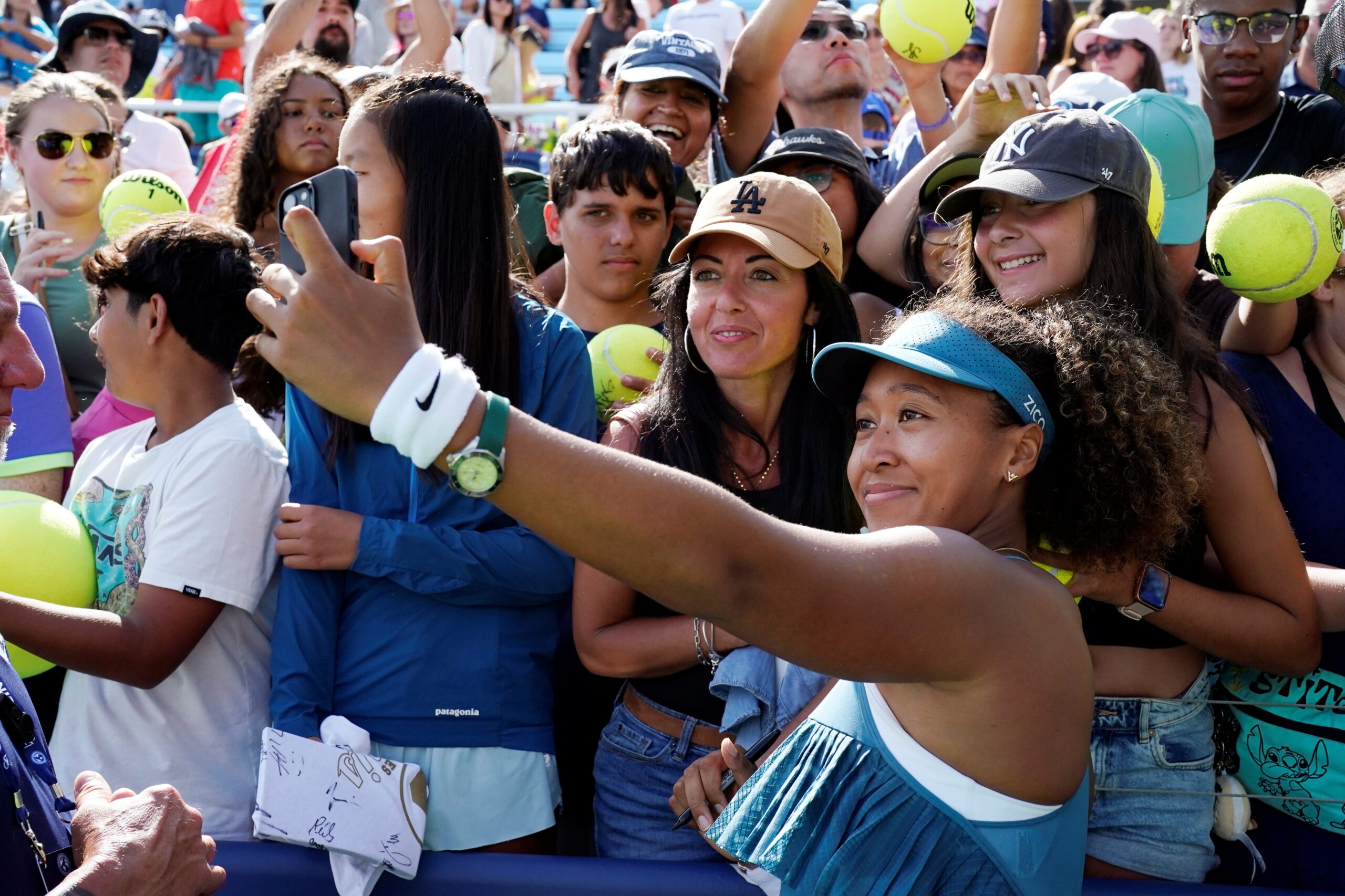 Naomi Osaka takes a selfie with fans