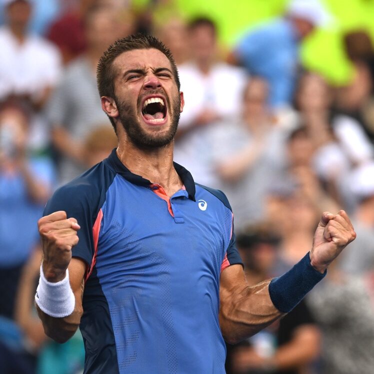 Borna Coric excitedly yelling with clenched fists