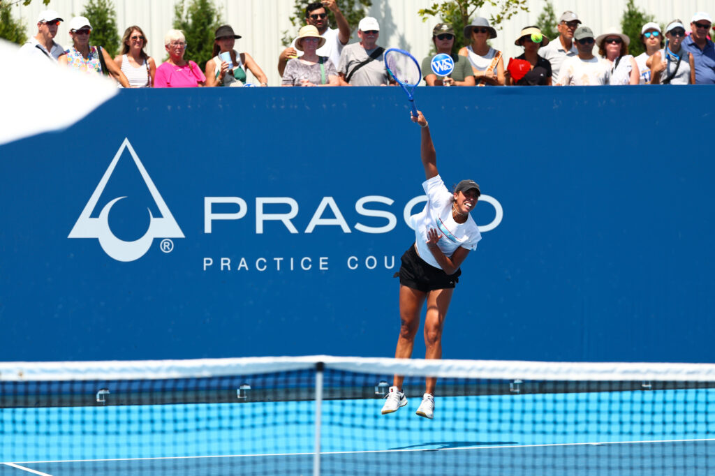 Madison Keys jumping and swinging a racket