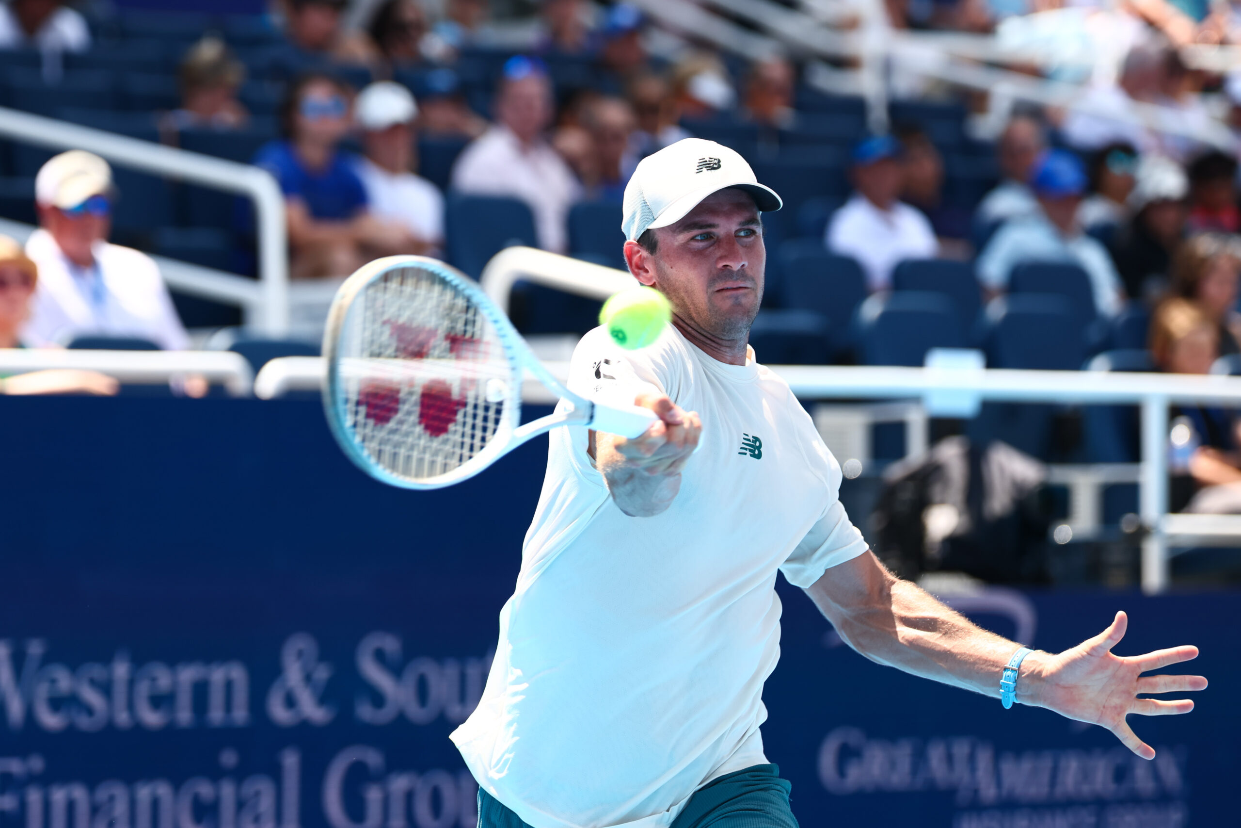 Tommy Paul hitting a tennis ball with a racket