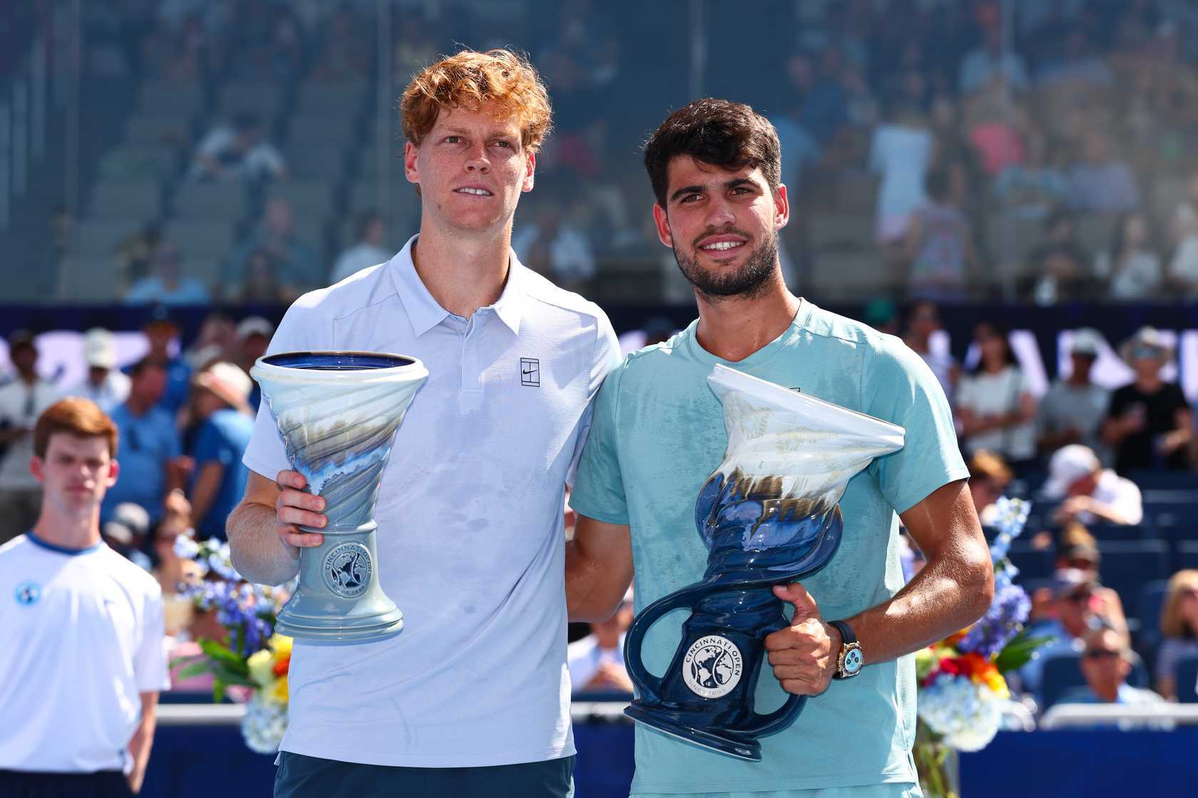 Jannik Sinner and Carlos Alcaraz holding trophies