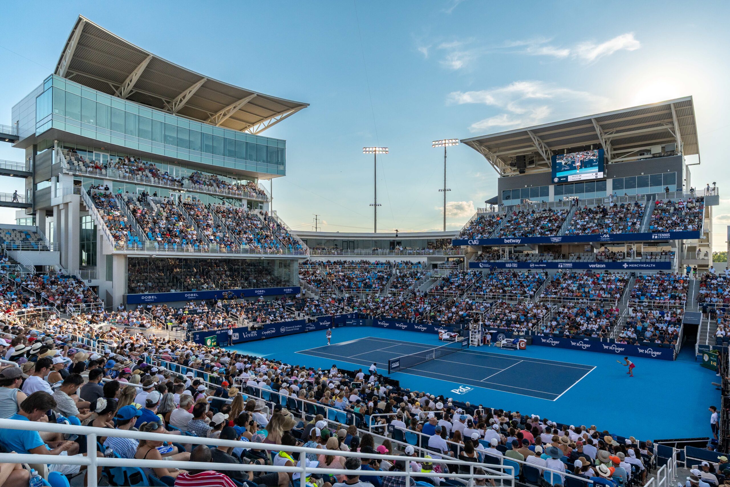 Tennis match being played on center court with the stands full