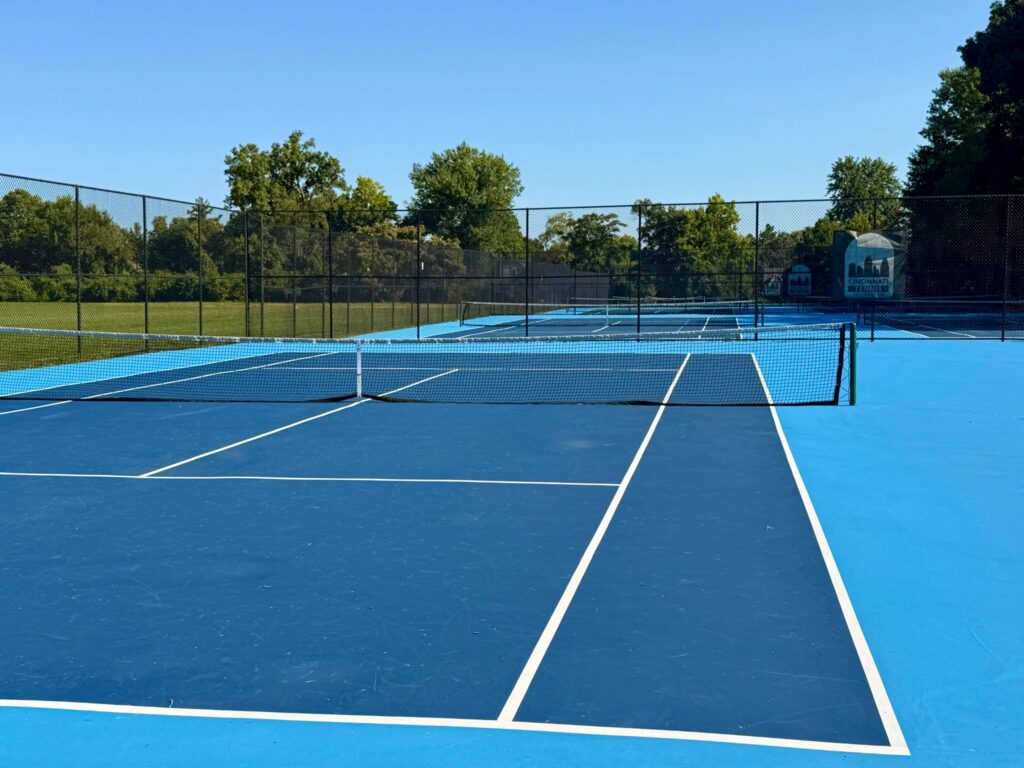 A low angle shot of a blue tennis court