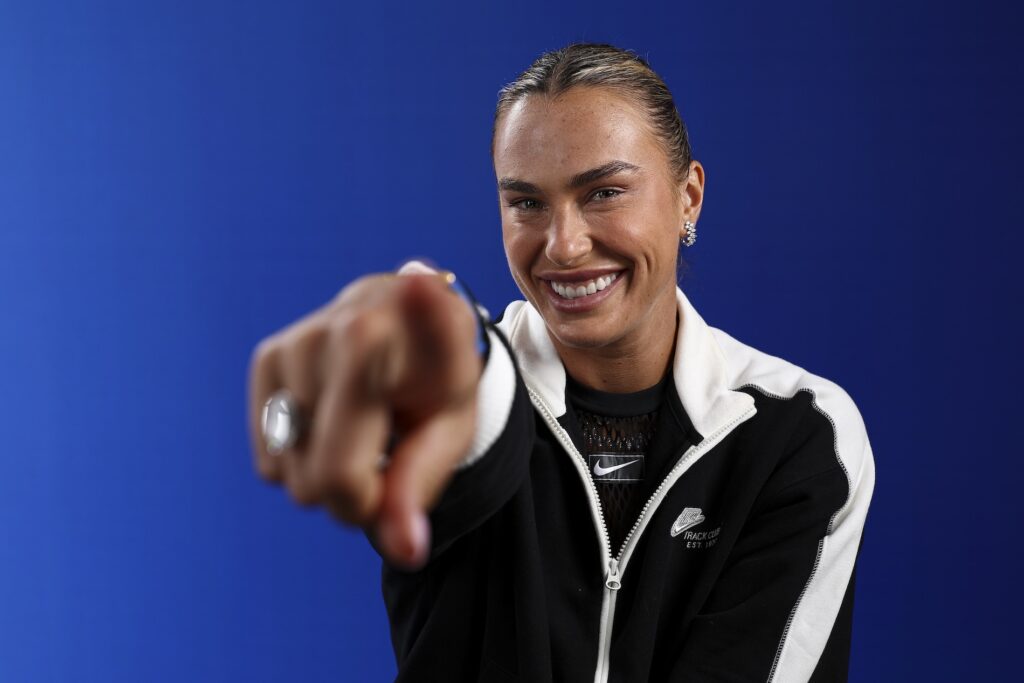 woman smiling and pointing at the camera