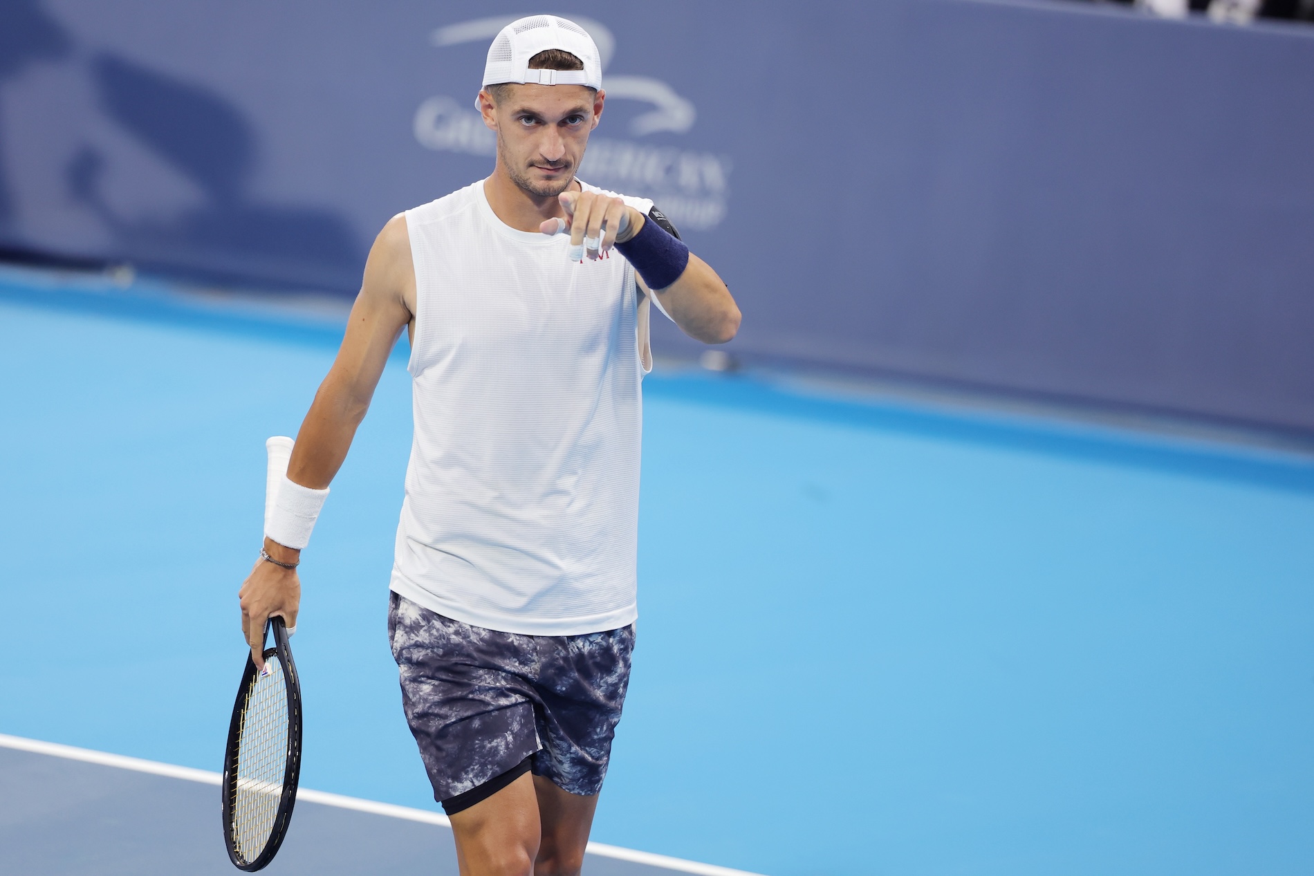 ATP tennis player on court pointing at the camera, ready to start the match