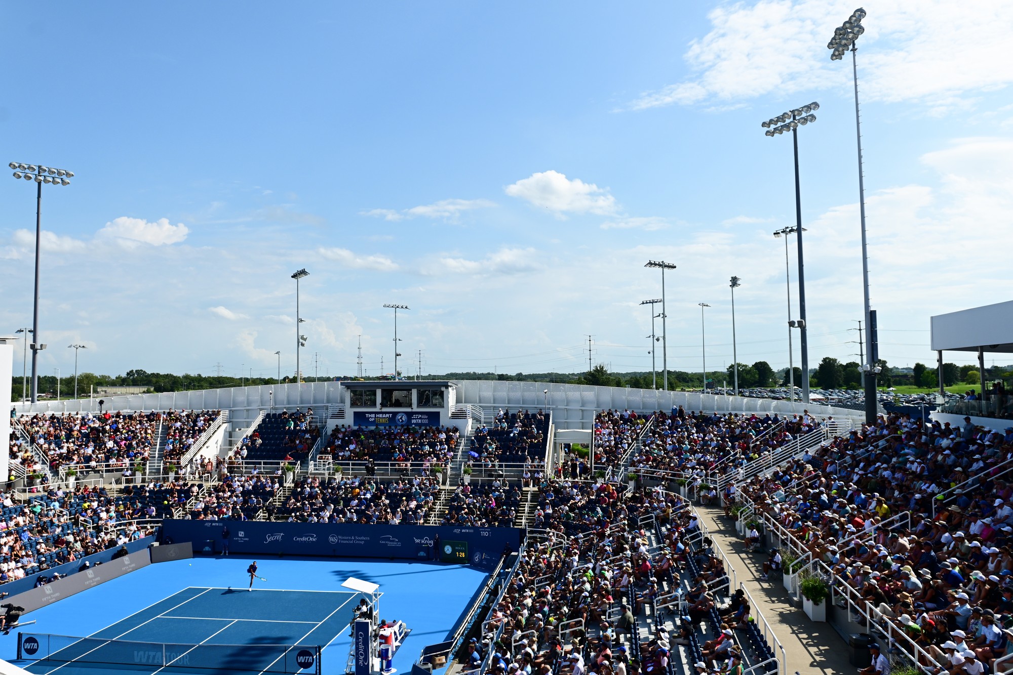 overhead view of a tennis match with a crowd full of spectators