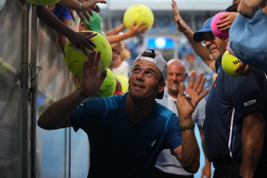 ATP player walking through a pathway of fans