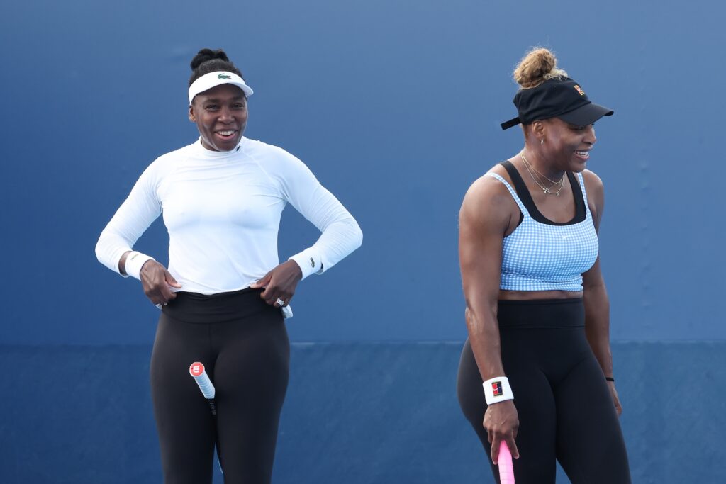 Serena and Venus Williams share a laugh on the court