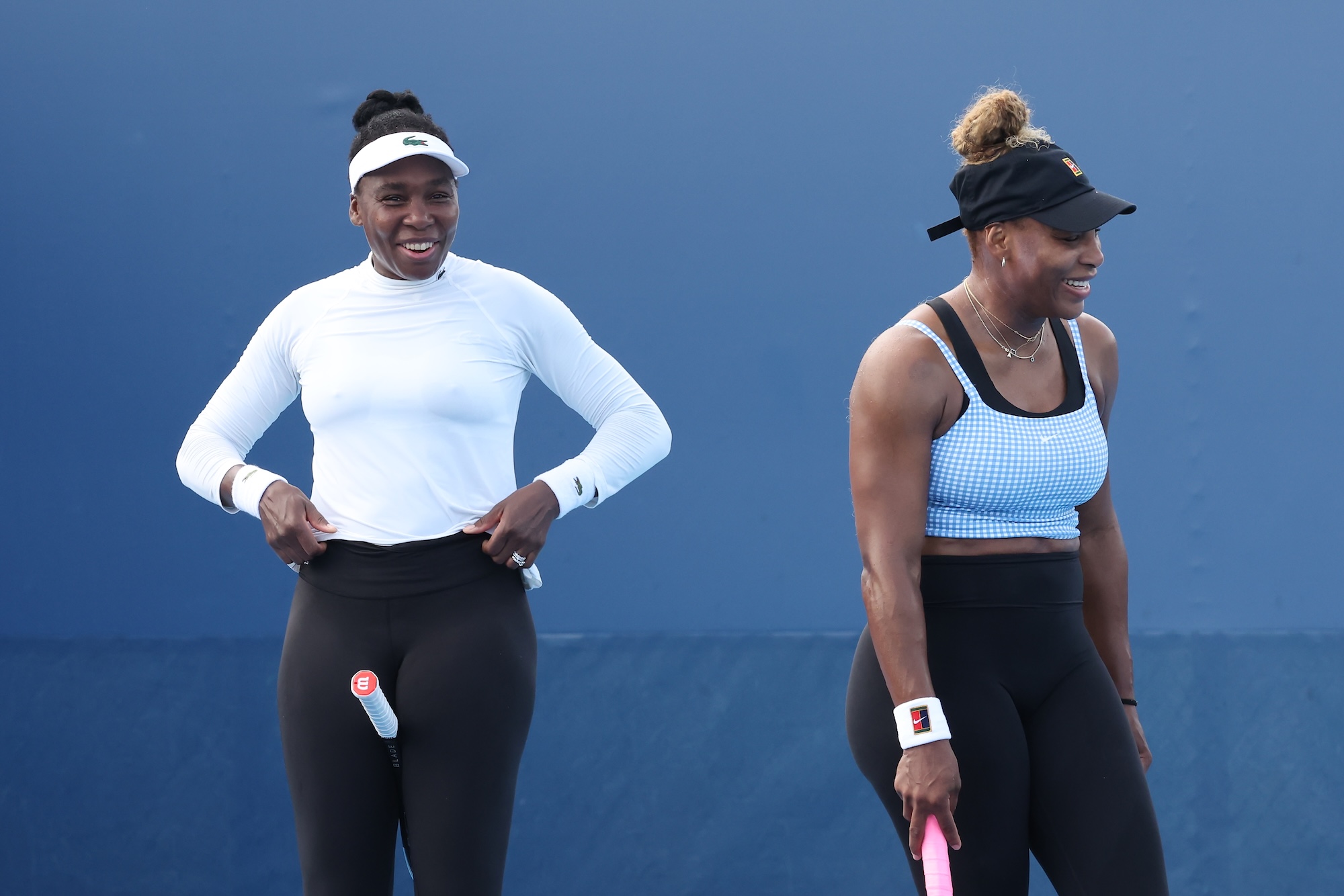 Serena and Venus Williams share a laugh on the court