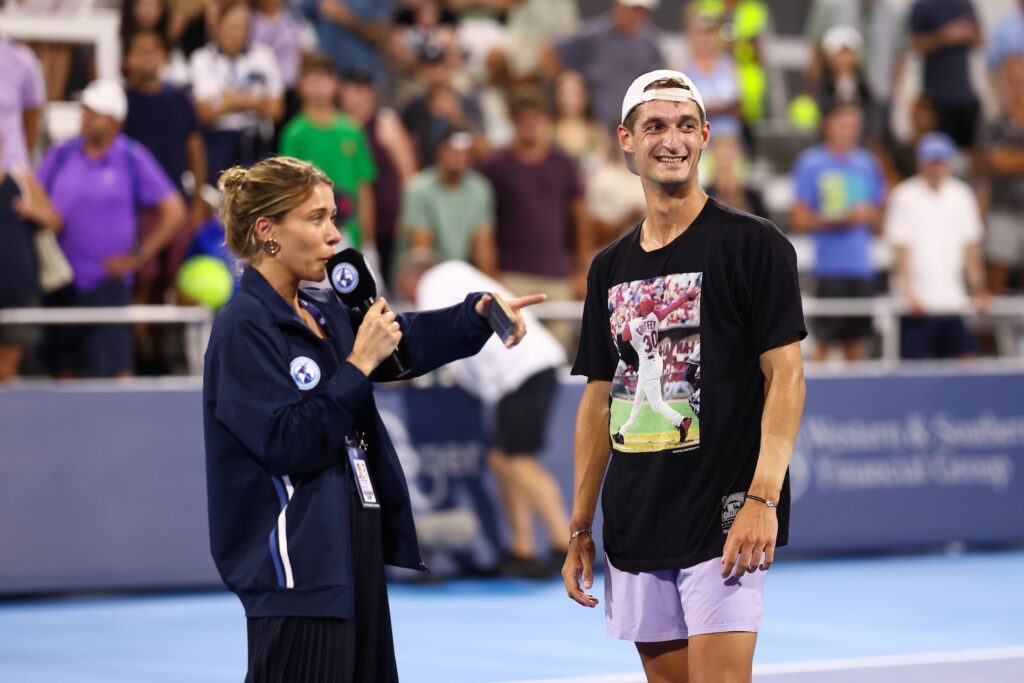 ATP player smilling and talking to the media on court