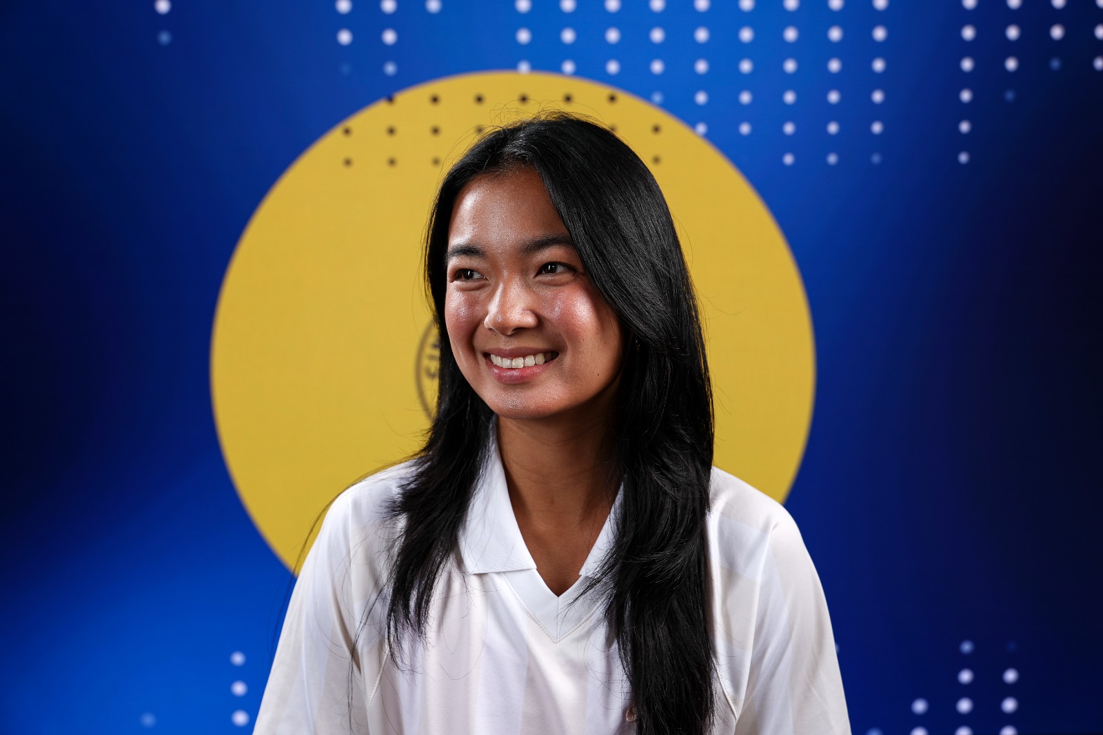 woman with long dark hair smiling before an interview