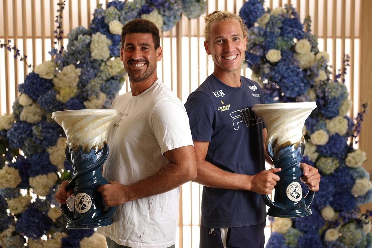 ATP doubles winners smile and pose with their trophies